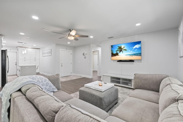 living room with hardwood / wood-style flooring and ceiling fan