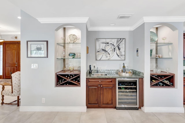 bar featuring wine cooler, a sink, visible vents, wet bar, and crown molding