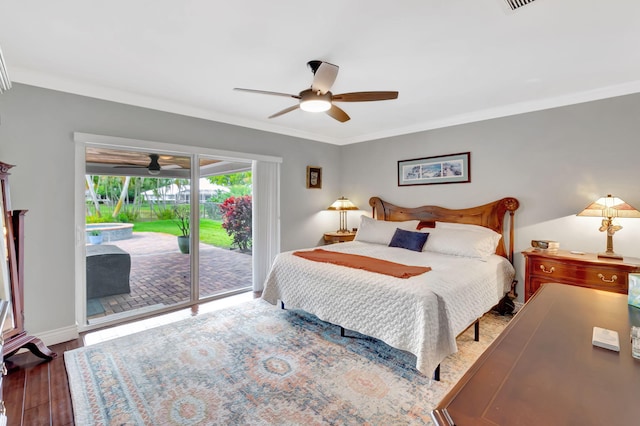 bedroom with crown molding, baseboards, wood finished floors, and access to exterior