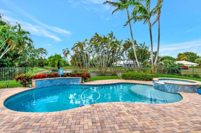 view of pool with a fenced backyard and a pool with connected hot tub