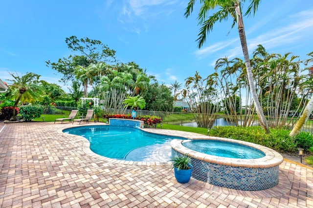 view of pool with a water view, a fenced backyard, a pool with connected hot tub, and a patio