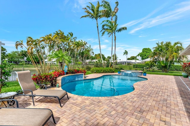 view of pool with a patio area, a fenced backyard, and a pool with connected hot tub