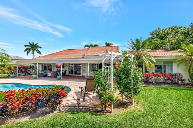 rear view of property with a lawn, a tiled roof, a patio area, outdoor lounge area, and a pergola