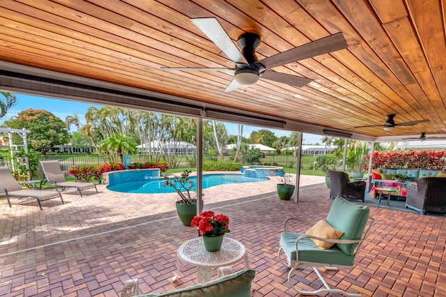 view of patio / terrace featuring ceiling fan, outdoor lounge area, a fenced backyard, and a pool with connected hot tub