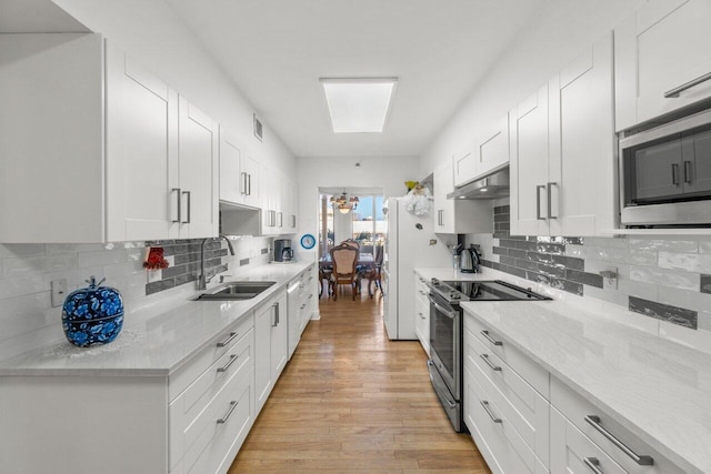 kitchen featuring white cabinetry, appliances with stainless steel finishes, sink, and extractor fan