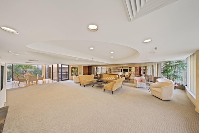 living room with light colored carpet and a wall of windows