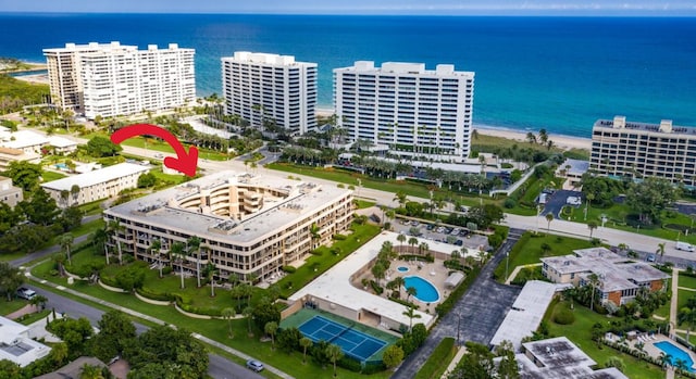 birds eye view of property featuring a view of the beach and a water view