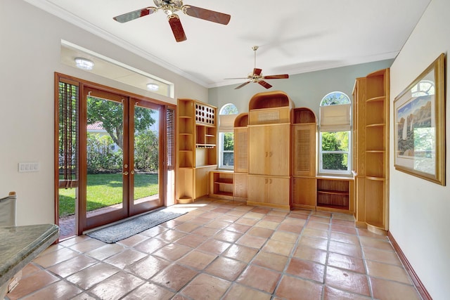 doorway with ornamental molding, french doors, and ceiling fan