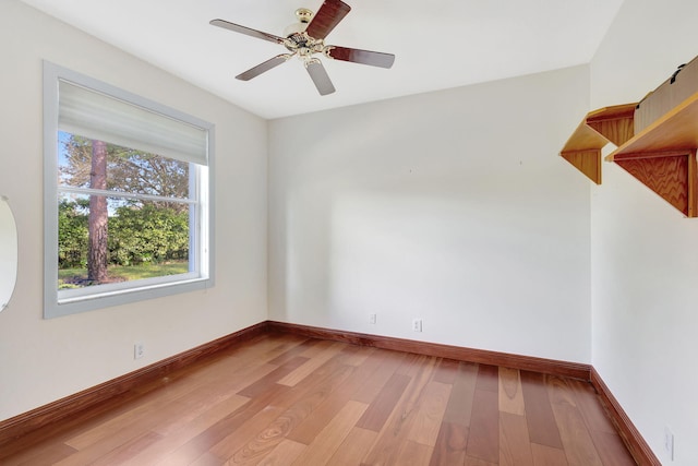 spare room featuring hardwood / wood-style floors and ceiling fan