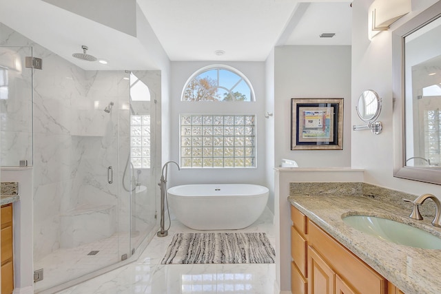 bathroom featuring vanity and separate shower and tub