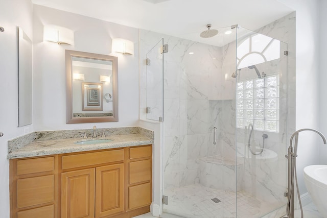 bathroom featuring an enclosed shower and vanity