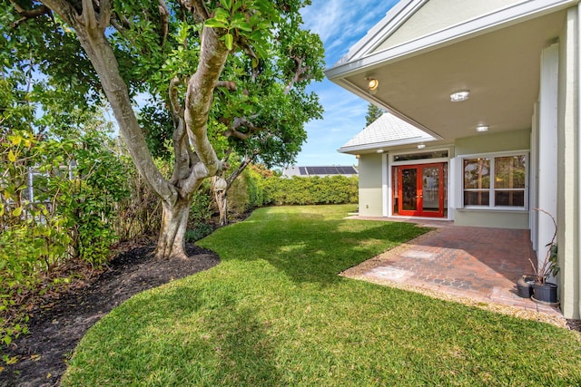 view of yard featuring french doors and a patio area