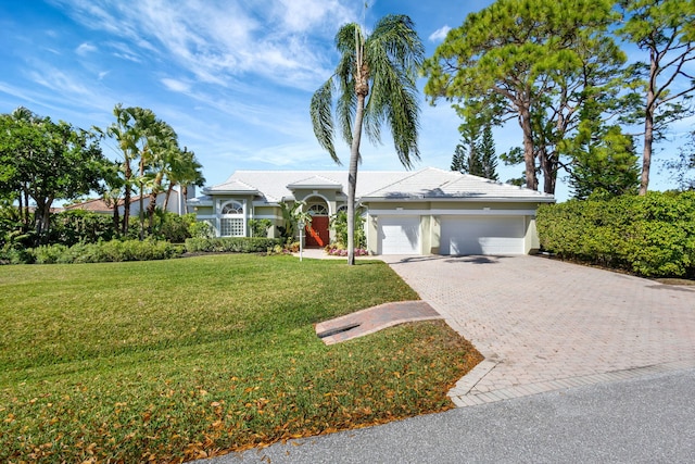 ranch-style house with a garage and a front yard