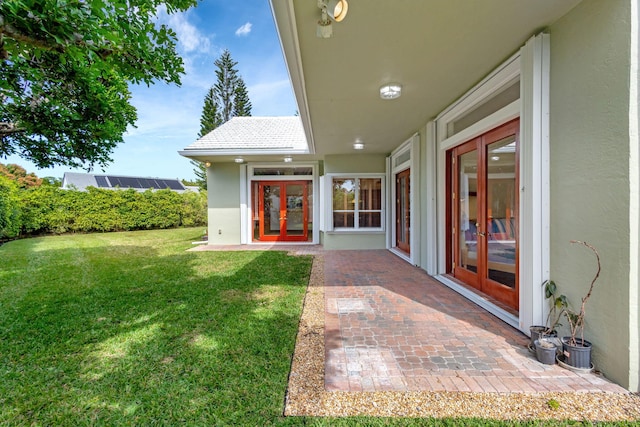 view of yard with a patio and french doors