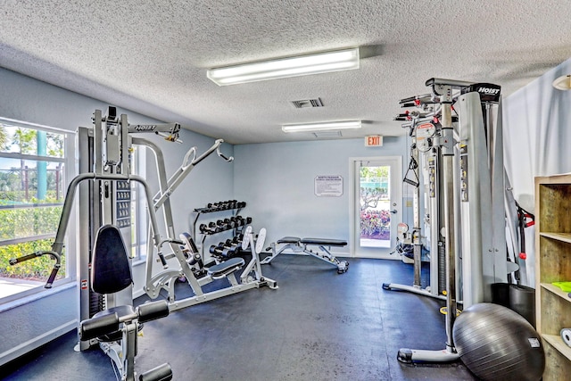 exercise room with a textured ceiling