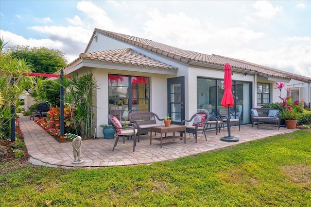 rear view of property with an outdoor hangout area, a patio, a yard, and stucco siding