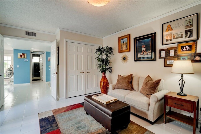 living area with a textured ceiling, ornamental molding, light tile patterned flooring, and visible vents