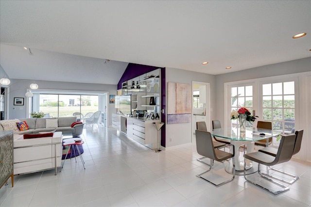 dining space with lofted ceiling, baseboards, and recessed lighting