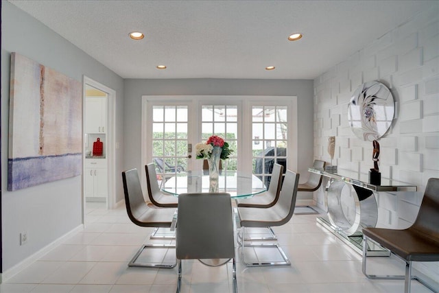 dining room featuring light tile patterned floors, baseboards, a textured ceiling, and recessed lighting