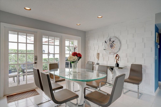 dining area featuring recessed lighting, a textured ceiling, and light tile patterned flooring