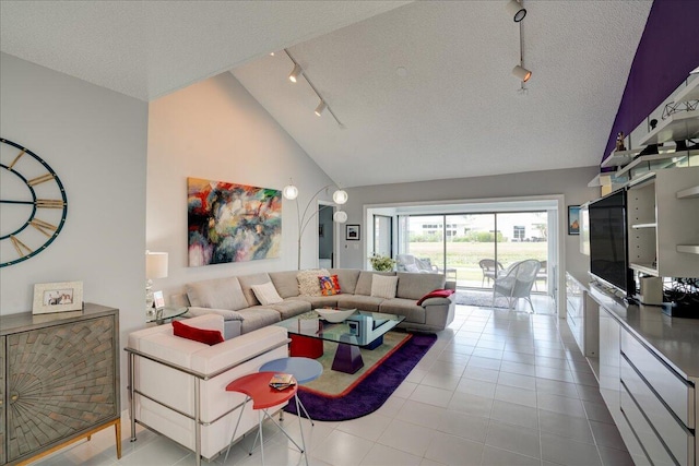 tiled living area featuring track lighting, high vaulted ceiling, and a textured ceiling