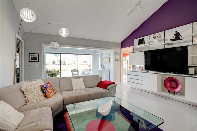 tiled living room featuring vaulted ceiling and track lighting