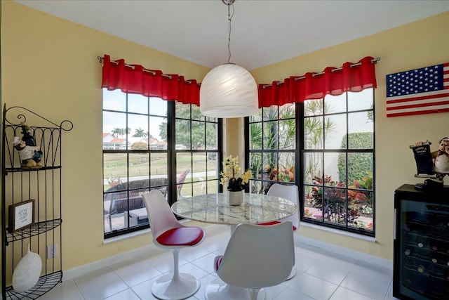 tiled dining space featuring wine cooler