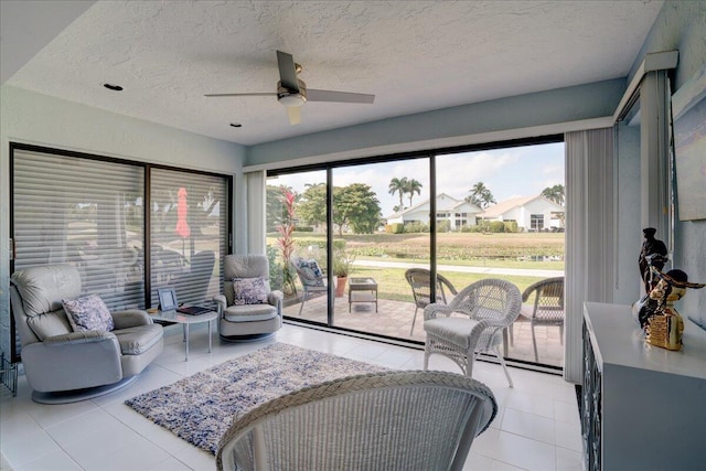 sunroom / solarium featuring a ceiling fan and a healthy amount of sunlight