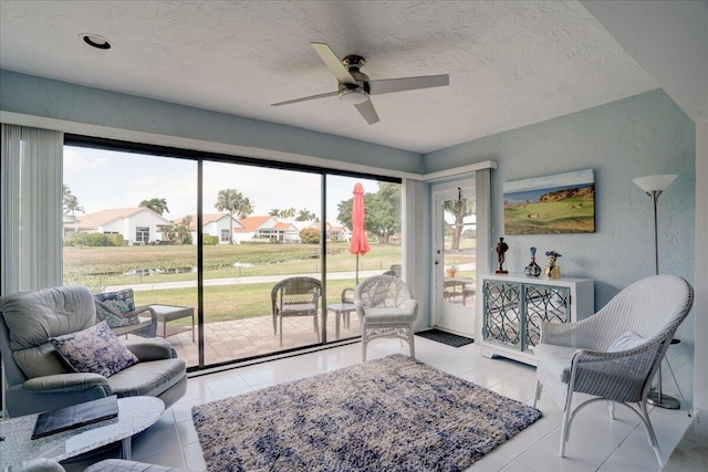 interior space with ceiling fan