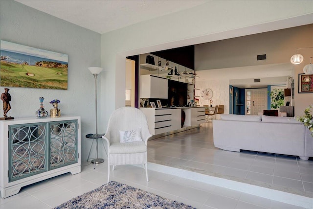 tiled living area featuring visible vents