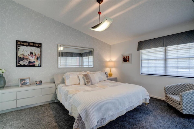 carpeted bedroom featuring vaulted ceiling and multiple windows