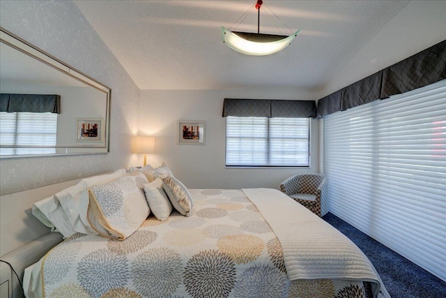 bedroom with a textured ceiling and lofted ceiling