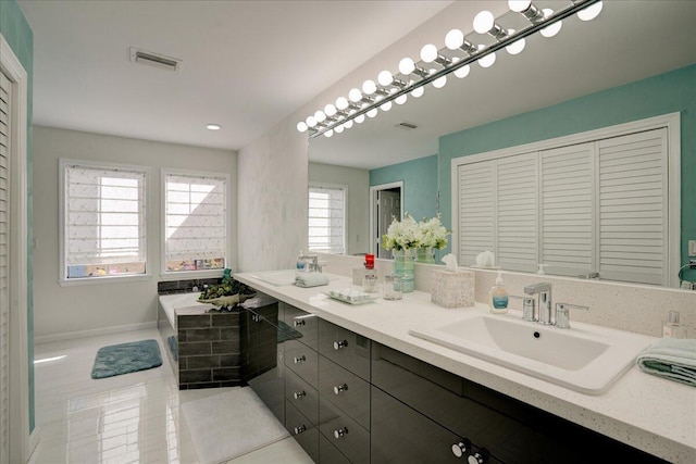 full bathroom with double vanity, a sink, visible vents, and tile patterned floors