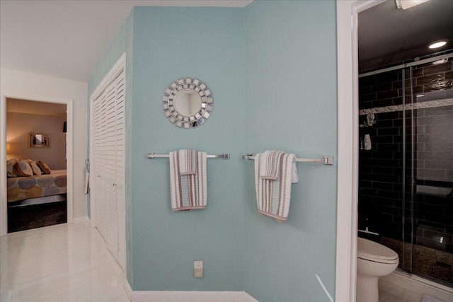 bathroom with toilet, a stall shower, tile patterned flooring, and connected bathroom