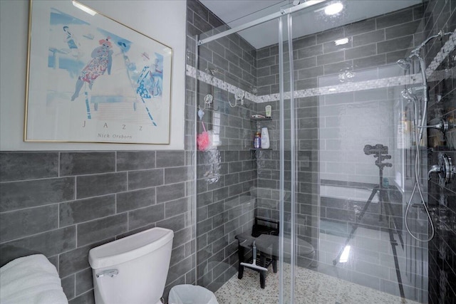 full bath featuring a shower stall and toilet