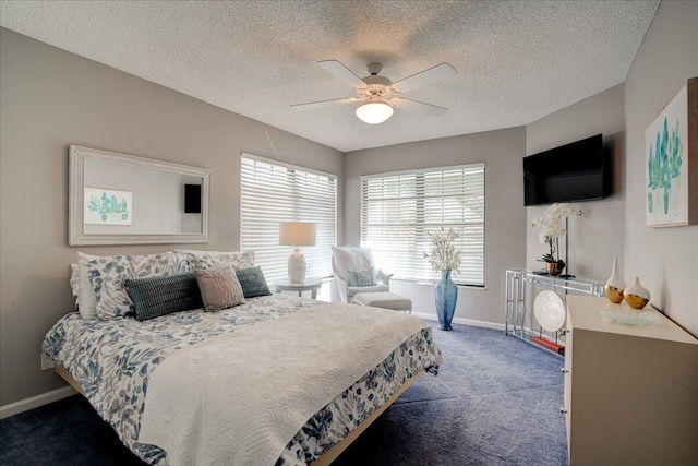 carpeted bedroom featuring ceiling fan, a textured ceiling, and baseboards