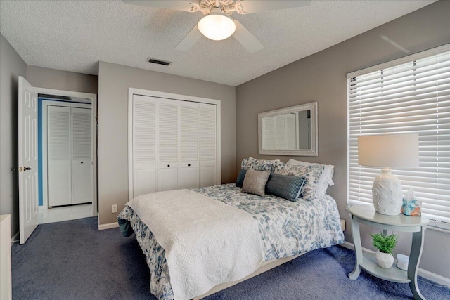 bedroom with visible vents, ceiling fan, a textured ceiling, and carpet flooring