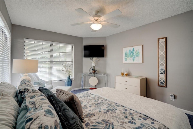 bedroom featuring a ceiling fan and a textured ceiling