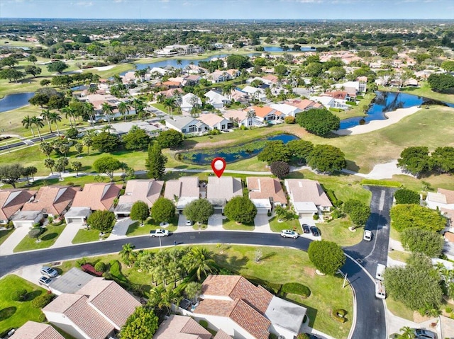 birds eye view of property with a water view and a residential view