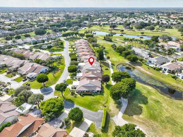 drone / aerial view featuring a water view, a residential view, and golf course view