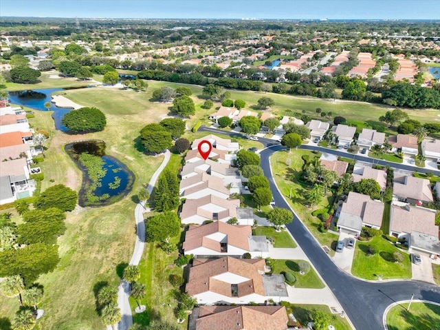 birds eye view of property with view of golf course, a water view, and a residential view