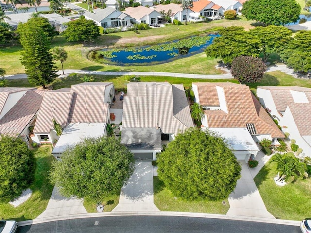 drone / aerial view with a water view and a residential view