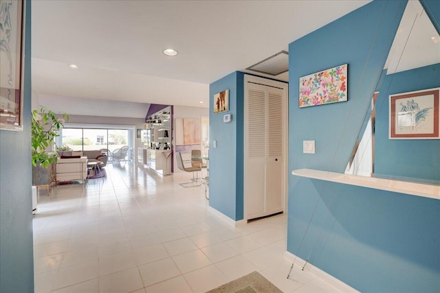 corridor featuring baseboards and recessed lighting