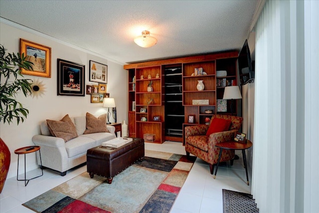 sitting room with light tile patterned floors, ornamental molding, and a textured ceiling