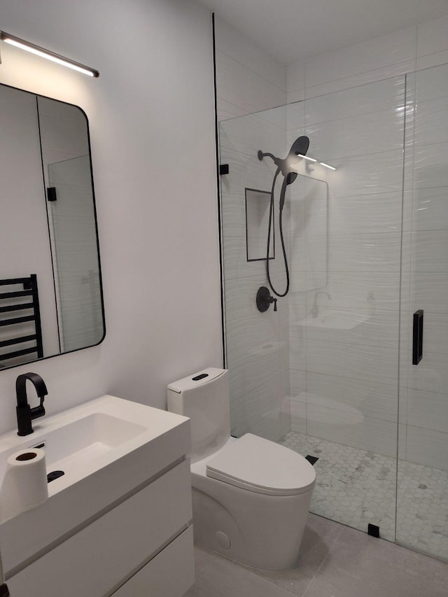 bathroom with tile patterned flooring, vanity, toilet, and walk in shower