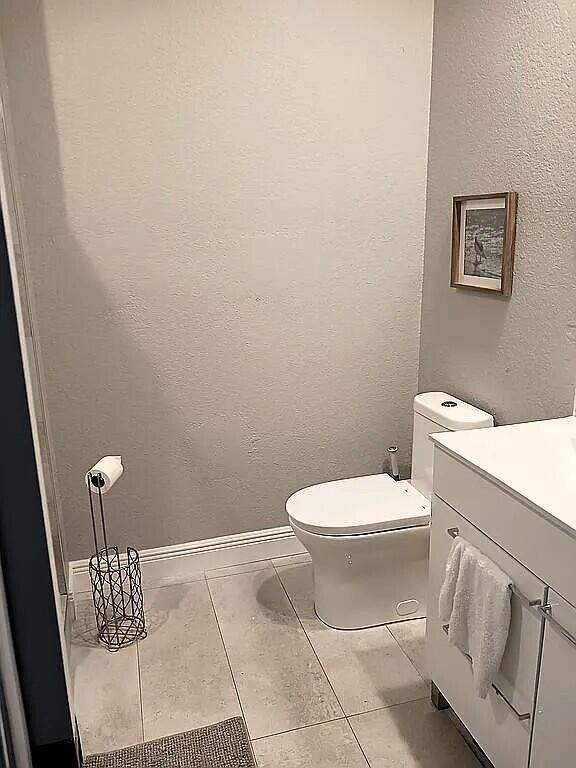 bathroom with tile patterned floors, vanity, and toilet