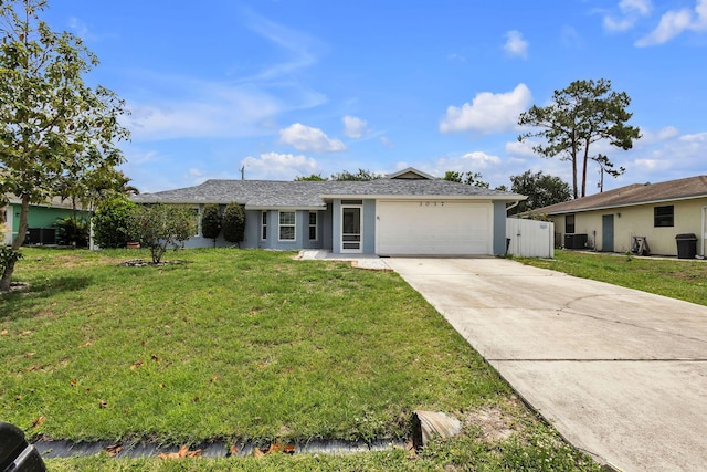 ranch-style house with a front yard, a garage, and cooling unit