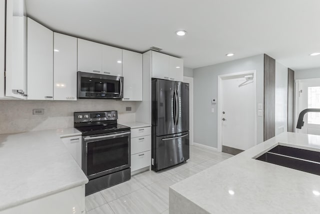 kitchen with ceiling fan, tasteful backsplash, sink, white cabinetry, and stainless steel appliances