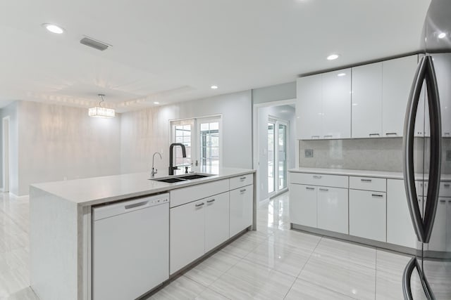 kitchen featuring a center island with sink, stainless steel fridge, dishwasher, white cabinets, and sink