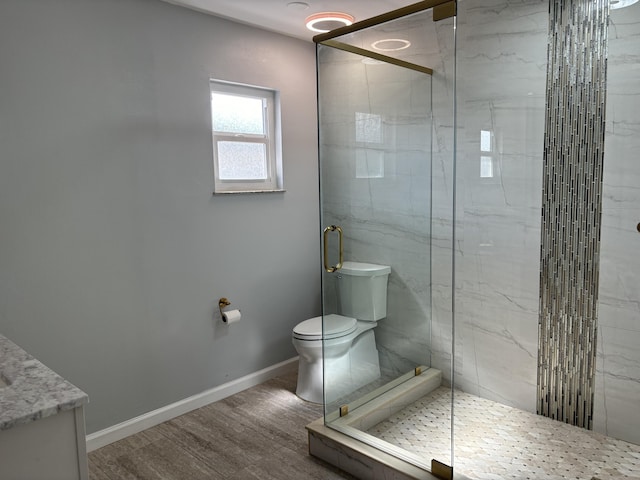 bathroom with toilet, wood-type flooring, and a shower with door